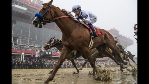 Justify, ridden by jockey Mike Smith, wins the Preakness Stakes at Pimlico Race Course on May 19, 2018, in Baltimore.