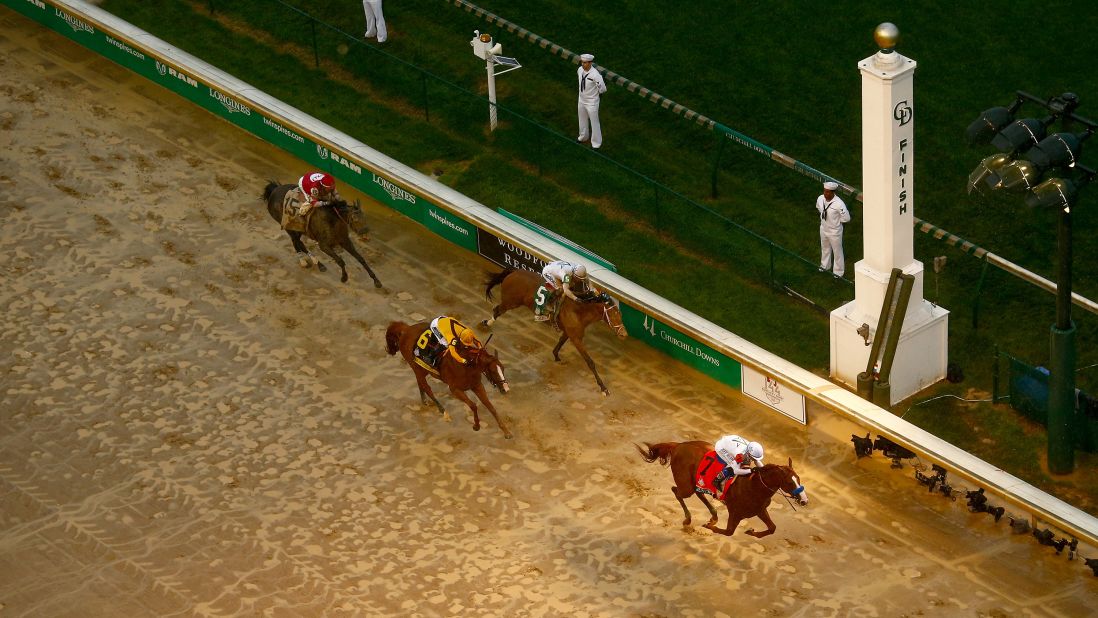 Justify, the No. 7 horse, crosses the finish line with jockey Mike Smith to win the 144th running of the Kentucky Derby at Churchill Downs on May 5, 2018, in Louisville, Kentucky.