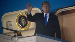 US President Donald Trump waves after Air Force One arrived at Paya Lebar Air Base in Singapore on June 10, 2018, ahead of his planned meeting with North Korea's leader. - Kim Jong Un and Donald Trump will meet on June 12 for an unprecedented summit in an attempt to address the last festering legacy of the Cold War, with the US president calling it a "one time shot" at peace. (Photo by SAUL LOEB / AFP)        (Photo credit should read SAUL LOEB/AFP/Getty Images)