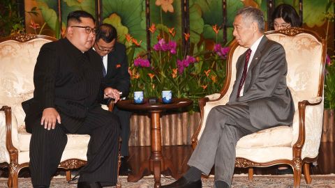 North Korea's leader Kim Jong Un talks with Singapore's Prime Minister Lee Hsien Loong during his visit to The Istana, the official residence of the prime minister, following Kim's arrival in Singapore.