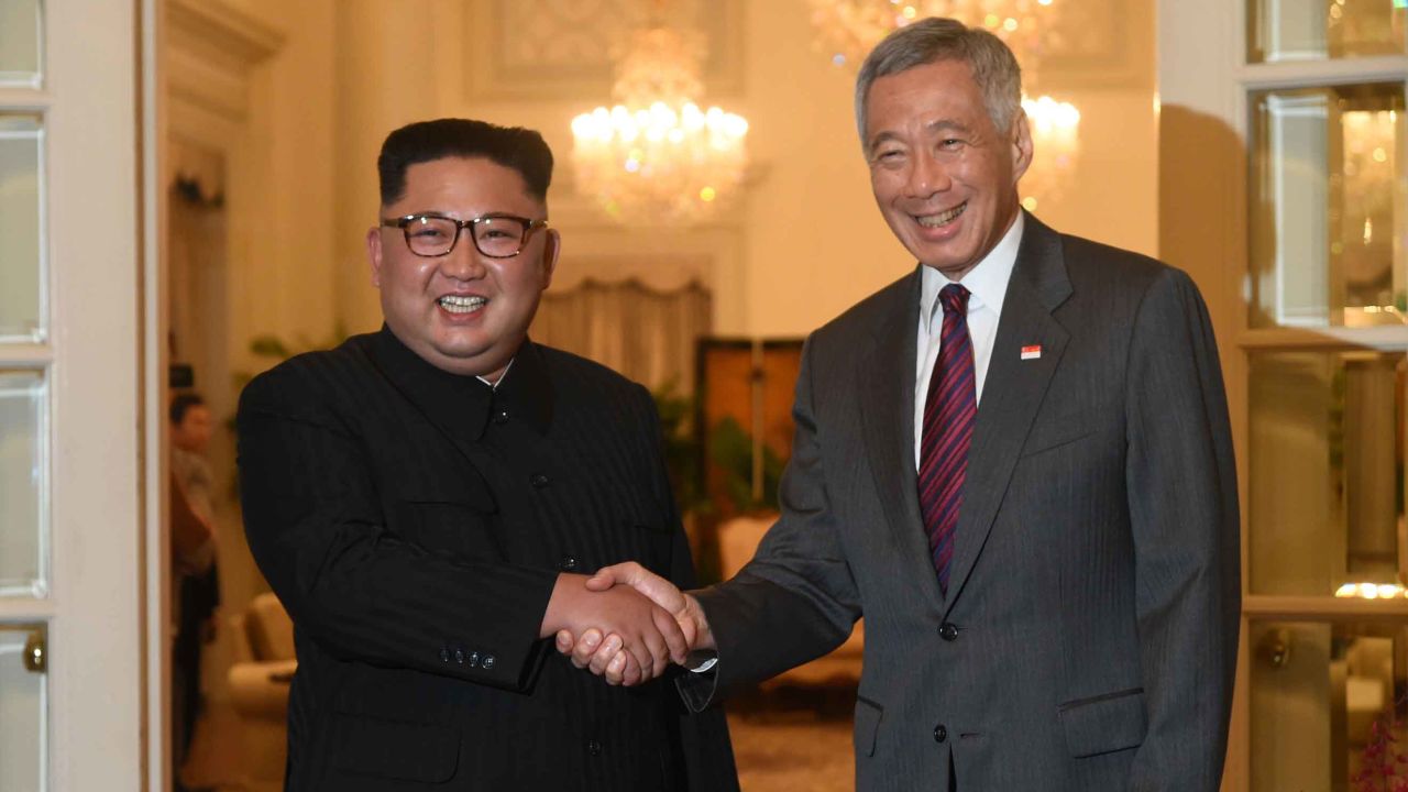 North Korea's leader Kim Jong Un (L) is welcomed by Singapore's Prime Minister Lee Hsien Loong (R) during his visit to The Istana, the official residence of the prime minister, following Kim's arrival in Singapore on June 10, 2018. - Kim Jong Un and Donald Trump will meet on June 12 for an unprecedented summit in an attempt to address the last festering legacy of the Cold War, with the US president calling it a "one time shot" at peace. (Photo by ROSLAN RAHMAN / AFP)        (Photo credit should read ROSLAN RAHMAN/AFP/Getty Images)