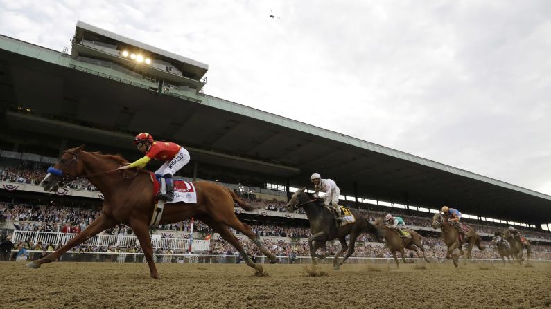 Justify, with jockey Mike Smith, <a href="index.php?page=&url=https%3A%2F%2Fwww.cnn.com%2F2018%2F06%2F09%2Fsport%2Ftriple-crown-justify-wins-belmont%2Findex.html" target="_blank">crosses the finish line to win</a> the 150th running of the Belmont Stakes horse race and the Triple Crown, on Saturday, June 9, in Elmont, New York. Justify is only the 13th horse ever to win the Triple Crown and the first since American Pharoah in 2015.