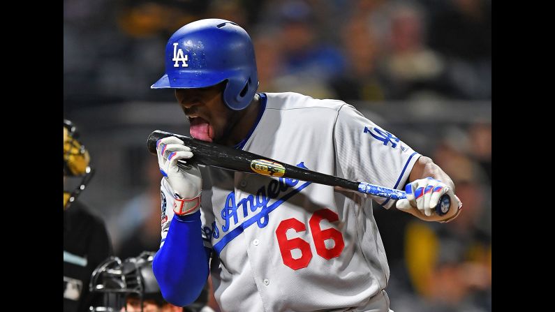 Yasiel Puig of the Los Angeles Dodgers licks his bat after hitting a foul ball during the eighth inning against the Pittsburgh Pirates on Wednesday, June 6, in Pittsburgh, Pennsylvania. 