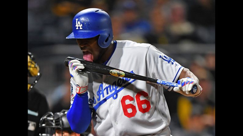 Yasiel Puig of the Los Angeles Dodgers licks his bat after hitting a foul ball during the eighth inning against the Pittsburgh Pirates on Wednesday, June 6, in Pittsburgh, Pennsylvania.