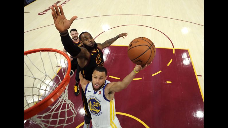 Stephen Curry, below, of the Golden State Warriors attempts a layup defended by LeBron James of the Cleveland Cavaliers in the third quarter during Game Three of the 2018 NBA Finals on Wednesday, June 6, in Cleveland, Ohio. 