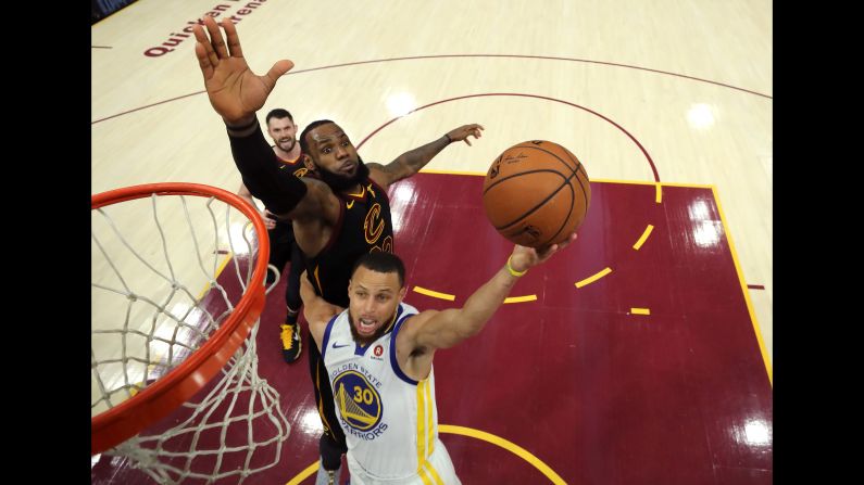 Stephen Curry, below, of the Golden State Warriors attempts a layup defended by LeBron James of the Cleveland Cavaliers in the third quarter during Game Three of the 2018 NBA Finals on Wednesday, June 6, in Cleveland, Ohio.