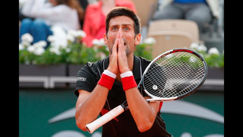 Novak Djokovic reacts after missing a shot against Marco Cecchinato in the tie break of the fourth set of their quarterfinal match at the French Open tennis tournament in Paris, on Tuesday, June 5.
