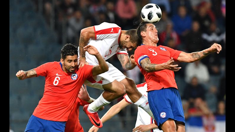 Serbia's Aleksandar Mitrovic, center, vies for the ball with Chile's captain Enzo Roco, right, and Guillermo Maripán during the international friendly football match between Serbia and Chile in Austria on Monday, June 4.