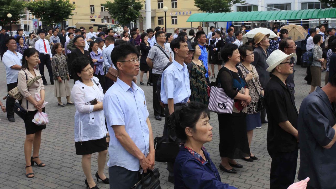 North Koreans in Pyongyang watch a news broadcast of Kim Jong Un's arrival in Singapore.