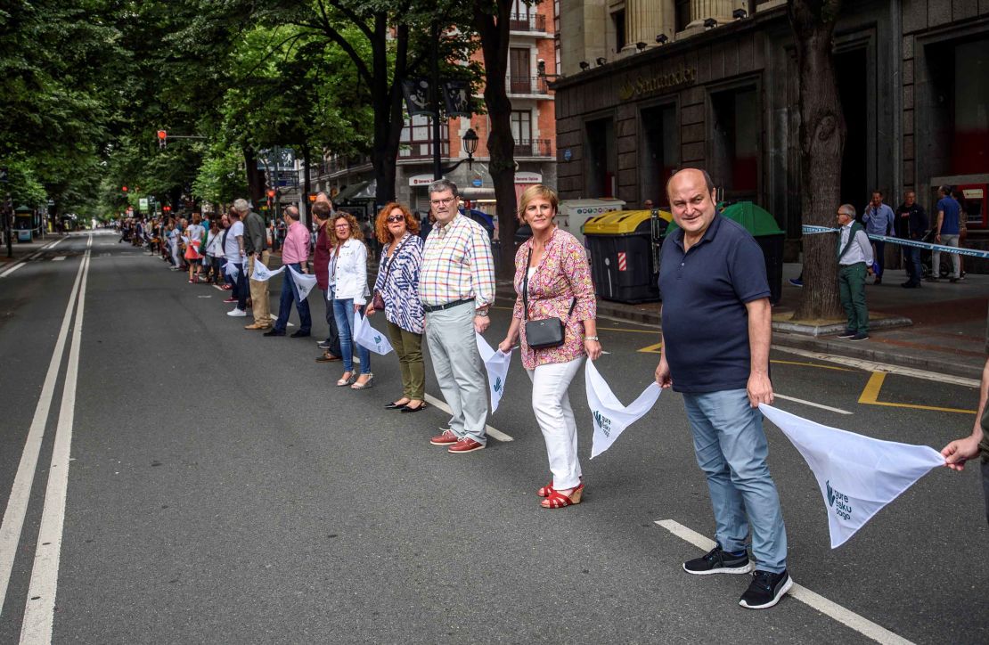 Basque Nationalist Party's senior officials Andoni Ortuzar (right to left) and Itxaso Atutxa and Bilbao Mayor Juan Mari Aburto take part in the human chain in Bilbao, northern Spain.