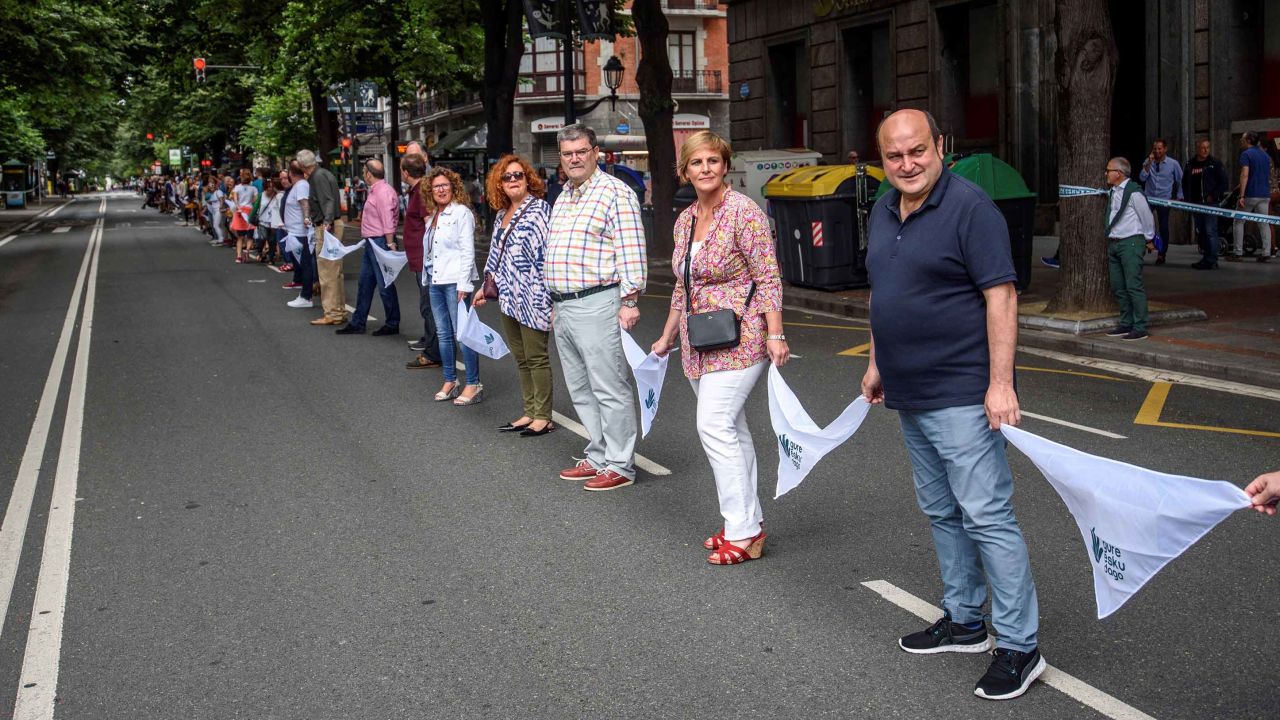 Basque Nationalist Party's senior officials Andoni Ortuzar (right to left) and Itxaso Atutxa and Bilbao Mayor Juan Mari Aburto take part in the human chain in Bilbao, northern Spain.