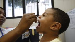 A child is seen receiving the polio vaccine dose in the city of Salvador, Brazil. 