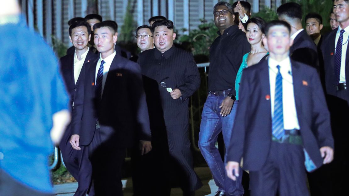 North Korea leader Kim Jong Un, center, is escorted by his security delegation as he visits Marina Bay in Singapore, Monday, June 11, 2018.