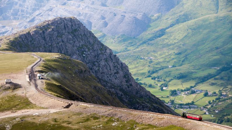 <strong>July in Wales:</strong> A train descends from the summit of Snowdon Mountain on the narrow gauge rack mountain railway. This is the spot for hiking and nature lovers.