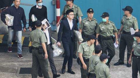 Pro-independence protestor Edward Leung (C) leaves for sentencing on rioting and assaulting a police officer in Hong Kong on June 11.