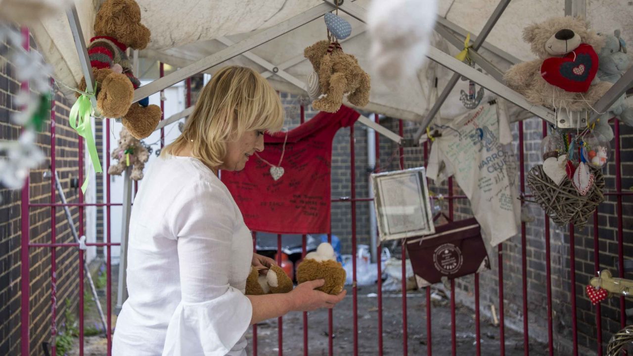 Bromley House resident Theresa Griffin holds a stuffed toy that has fallen apart at the memorial she tends in tribute to Grenfell victims.