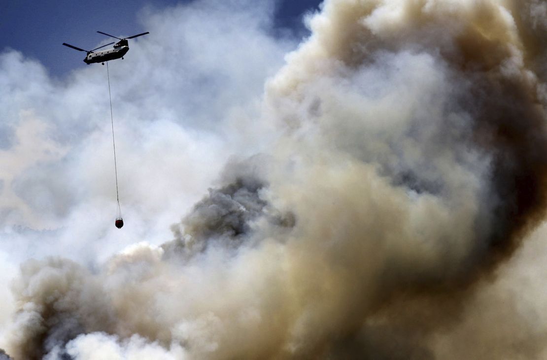 A helicopter works the wildfire on the east side of Hermosa Cliffs near Hermosa, Colorado.