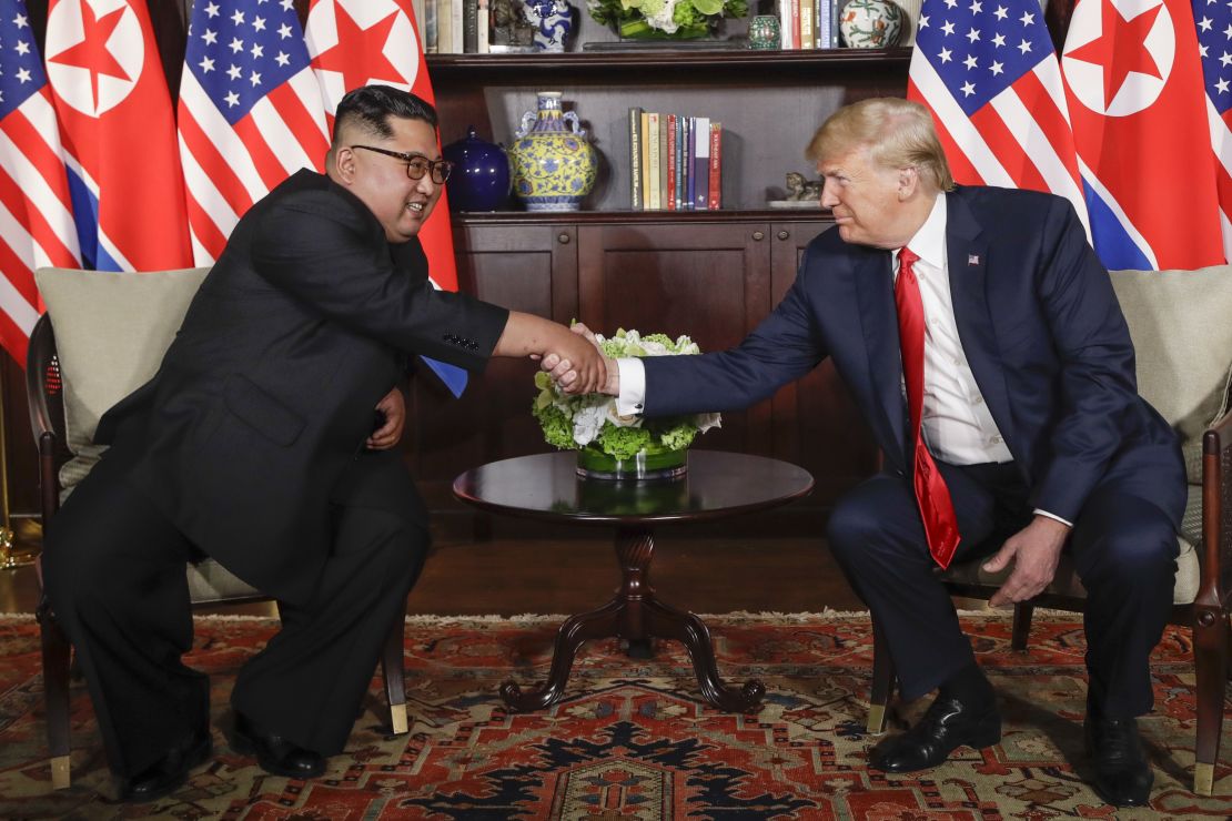 Trump shakes hands with North Korea leader Kim Jong Un during their first meetings at the Capella resort on Sentosa Island Tuesday, June 12, 2018 in Singapore. 