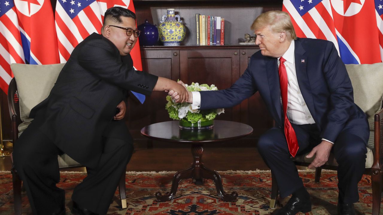 Trump shakes hands with North Korea leader Kim Jong Un during their first meetings at the Capella resort on Sentosa Island Tuesday, June 12, 2018 in Singapore.