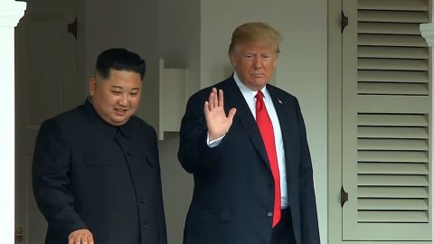US President Donald Trump and North Korea's leader Kim Jong Un walk through the Capella Hotel after concluding the first series of talks.