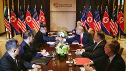 US President Donald Trump (3rd R) shakes hands with North Korea's leader Kim Jong Un (3rd L) as they sit down with their respective delegations for the US-North Korea summit, at the Capella Hotel on Sentosa island in Singapore on June 12, 2018.]