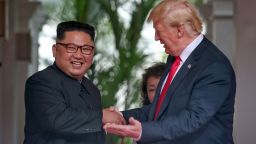 SINGAPORE - JUNE 12: In this handout photo, North Korean leader Kim Jong-un shakes hands with U.S. President Donald Trump during their historic U.S.-DPRK summit at the Capella Hotel on Sentosa island on June 12, 2018 in Singapore. U.S. President Trump and North Korean leader Kim Jong-un held the historic meeting between leaders of both countries on Tuesday morning in Singapore, carrying hopes to end decades of hostility and the threat of North Korea's nuclear program. (Photo by Kevin Lim/THE STRAITS TIMES/Handout/Getty Images)