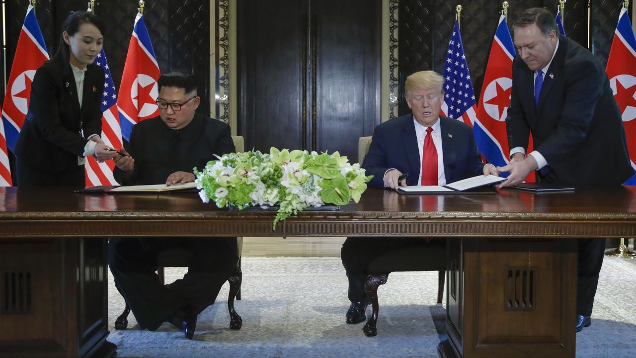 North Korea leader Kim Jong Un and U.S. President Donald Trump prepare to sign a document at the Capella resort on Sentosa Island Tuesday, June 12, 2018 in Singapore.