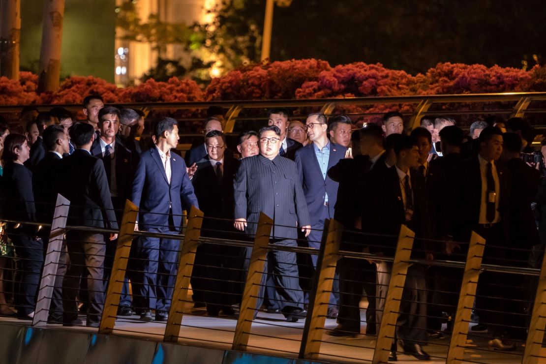 North Korean leader Kim Jong-Un (C) walks on the Jubilee bridge during a tour in Singapore on June 11, 2018. 