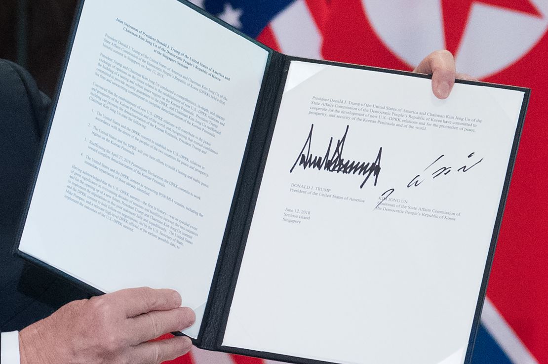 US President Donald Trump holds up a document signed by him and North Korea's leader Kim Jong Un following a signing ceremony during their historic US-North Korea summit, at the Capella Hotel on Sentosa island in Singapore on June 12, 2018. - Donald Trump and Kim Jong Un became on June 12 the first sitting US and North Korean leaders to meet, shake hands and negotiate to end a decades-old nuclear stand-off. (Photo by SAUL LOEB / AFP) (Photo credit should read SAUL LOEB/AFP/Getty Images)