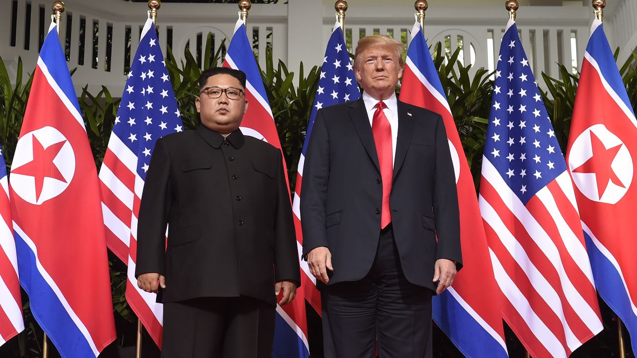 TOPSHOT - US President Donald Trump (R) poses with North Korea's leader Kim Jong Un (L) at the start of their historic US-North Korea summit, at the Capella Hotel on Sentosa island in Singapore on June 12, 2018. - Donald Trump and Kim Jong Un have become on June 12 the first sitting US and North Korean leaders to meet, shake hands and negotiate to end a decades-old nuclear stand-off. (Photo by SAUL LOEB / AFP)        (Photo credit should read SAUL LOEB/AFP/Getty Images)