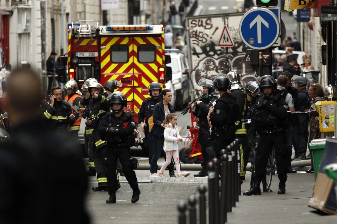 A woman and young girl are evacuated by police Tuesday during a hostage situation in Paris.