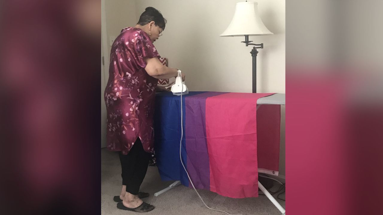 Hermina Nobrega, 72, irons her granddaughter's bisexual Pride flag. 