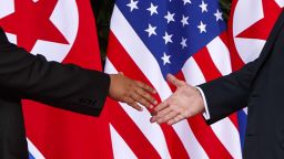 U.S. President Donald Trump, right, reaches to shakes hands with North Korea leader Kim Jong Un at the Capella resort on Sentosa Island Tuesday, June 12, 2018 in Singapore. (AP Photo/Evan Vucci)