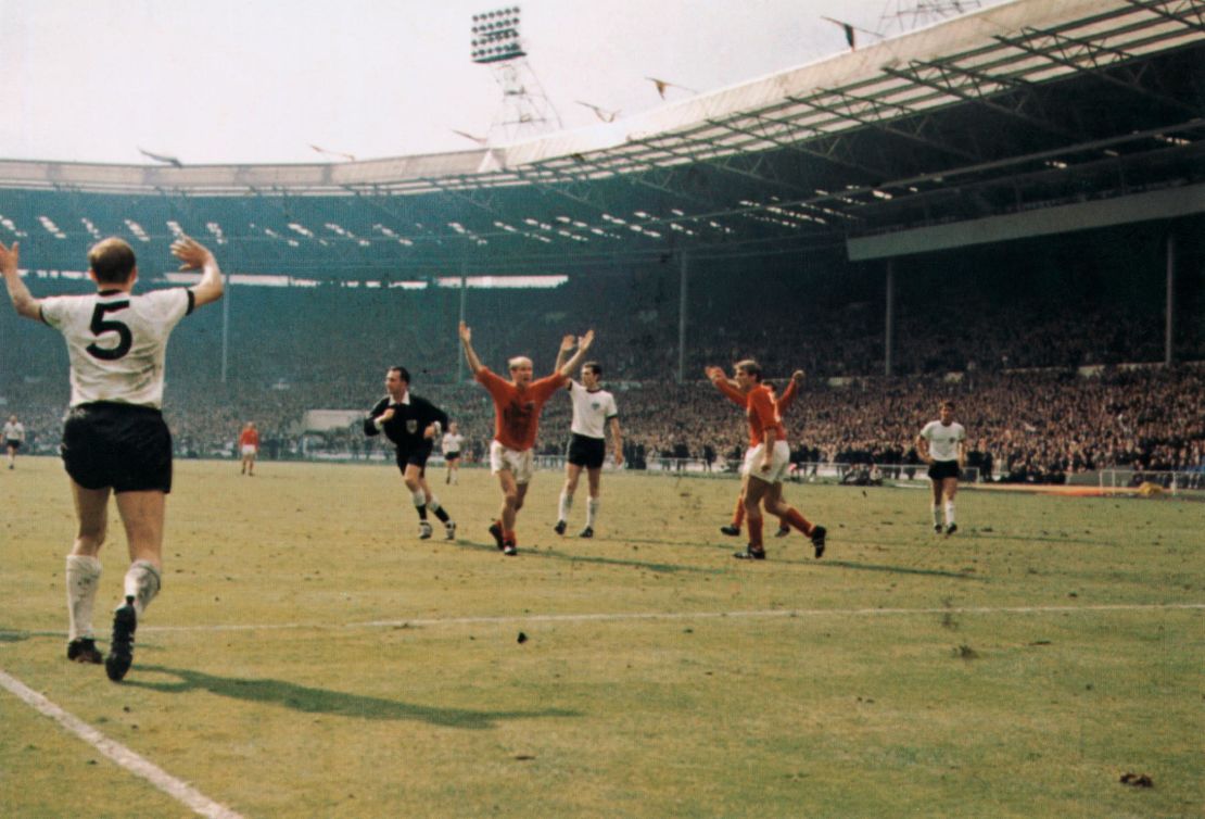 Bobby Charlton (centre) holds his hands up as West German players protest after Geoff Hurst scores the controversial third goal during the World Cup final at Wembley Stadium.