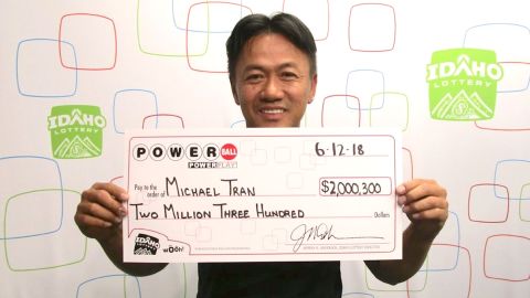 Michael Tran claims his lottery winnings on Tuesday.