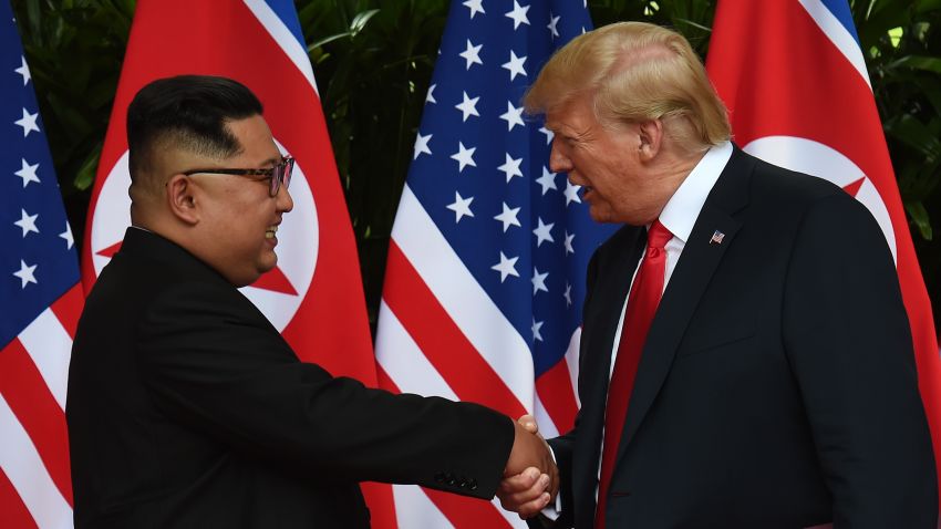 TOPSHOT - North Korea's leader Kim Jong Un (L) shakes hands with US President Donald Trump (R) after taking part in a signing ceremony at the end of their historic US-North Korea summit, at the Capella Hotel on Sentosa island in Singapore on June 12, 2018. - Donald Trump and Kim Jong Un became on June 12 the first sitting US and North Korean leaders to meet, shake hands and negotiate to end a decades-old nuclear stand-off. (Photo by Anthony WALLACE / POOL / AFP)        (Photo credit should read ANTHONY WALLACE/AFP/Getty Images)