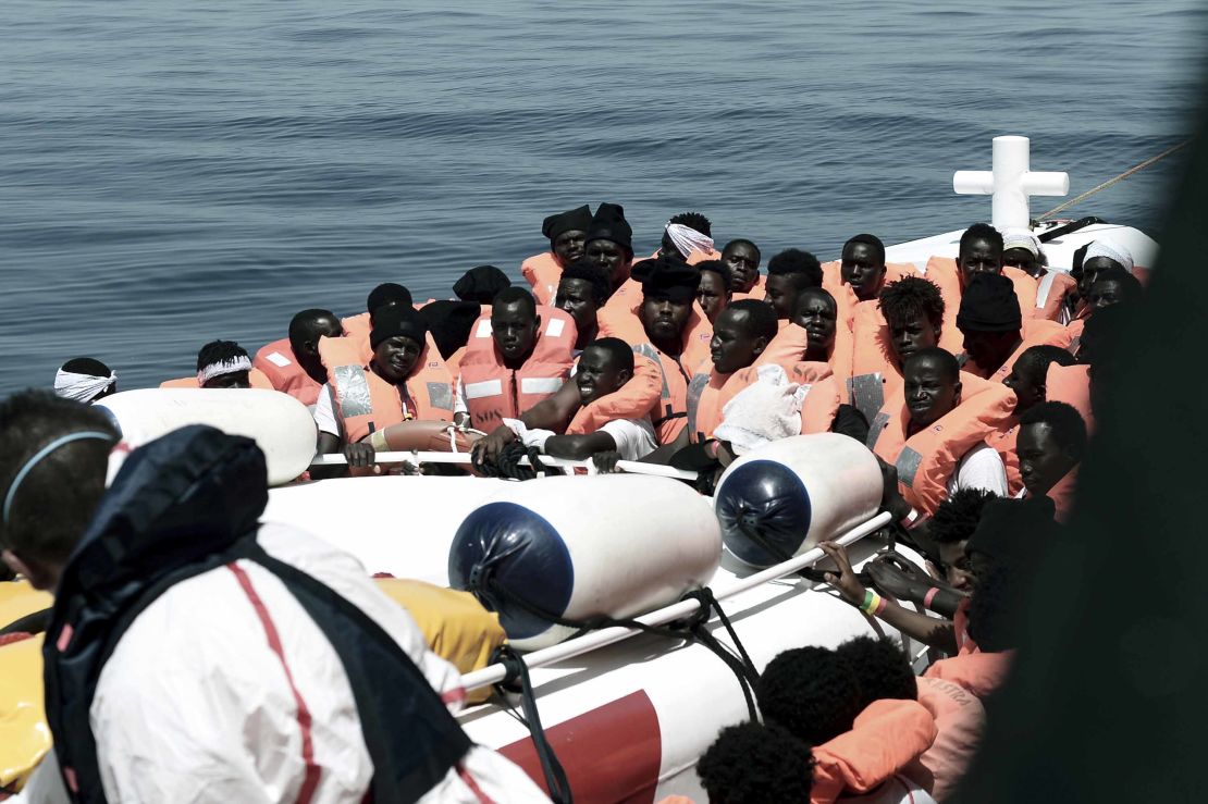 This undated photo released on Tuesday by SOS Méditerranée  shows stranded migrants from the Aquarius being transfered to an Italian Coast Guard boat before embarking on a journey to Spain. 