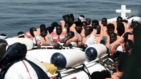 This undated photo released on Tuesday by SOS Méditerranée  shows stranded migrants from the Aquarius being transfered to an Italian Coast Guard boat before embarking on a journey to Spain. 