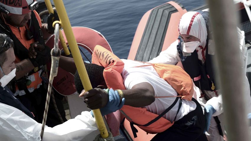 This handout photo released on Tuesday, June 12, 2018 by French NGO "SOS Mediterranee" shows migrants being transferred from the Aquarius ship, in the Mediterranean Sea. Italy dispatched two ships Tuesday to help take 629 migrants stuck off its shores on the days-long voyage to Spain in what is forecast to be bad weather, after the new populist government refused them safe port in a dramatic bid to force Europe to share the burden of unrelenting arrivals. (Kenny Karpov/SOS Mediterranee via AP)