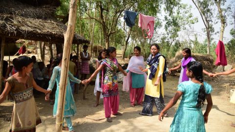 Rajni Devi (center, in light pink) helps coach girls in her small village, in Uttar Pradesh, on how to get an education and achieve dreams beyond marriage. 