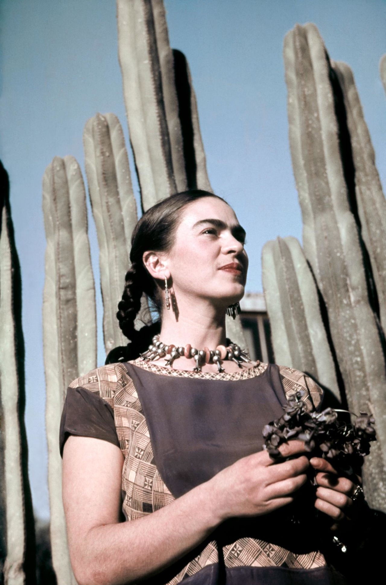 Frida Kahlo poses outside her home and studio in Mexico City circa 1940.