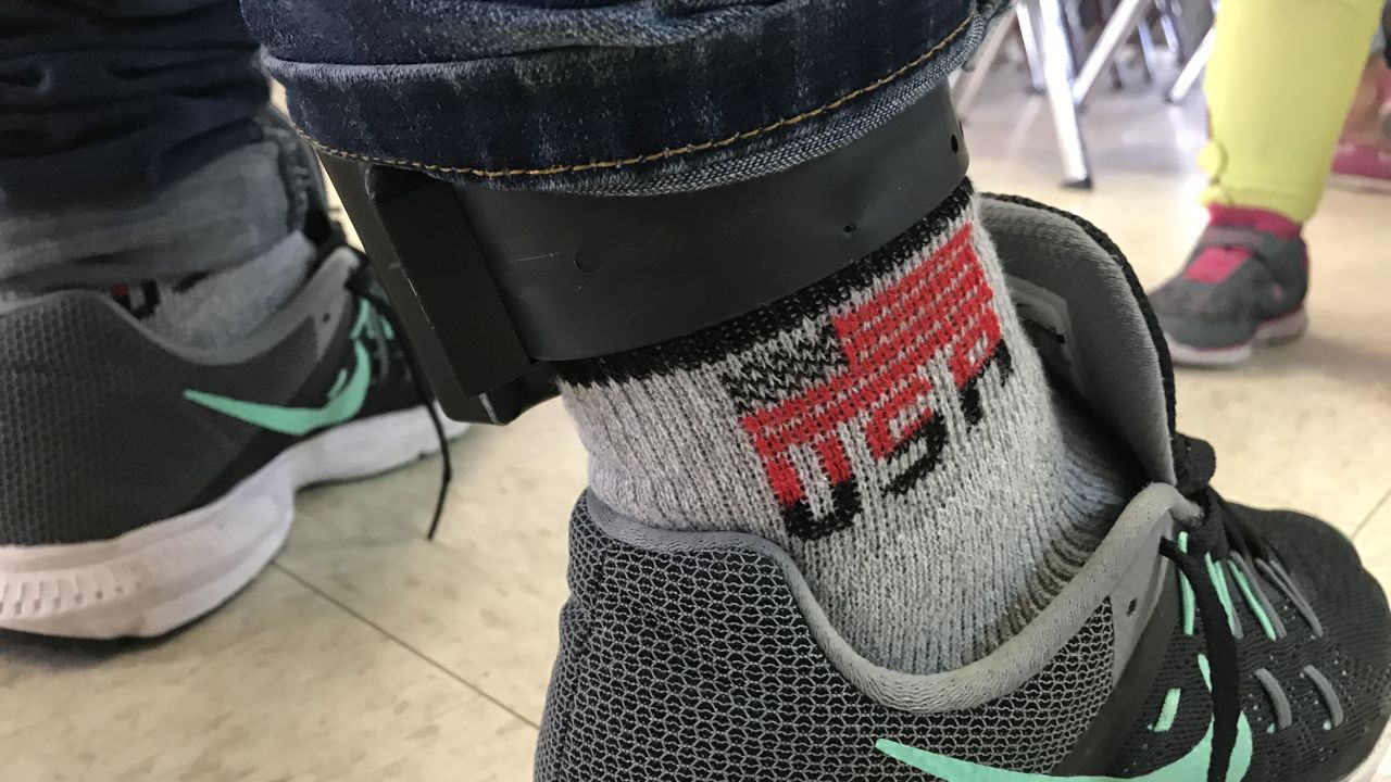 An undocumented immigrant from Guatemala who came to the US illegally wears a GPS ankle monitor.