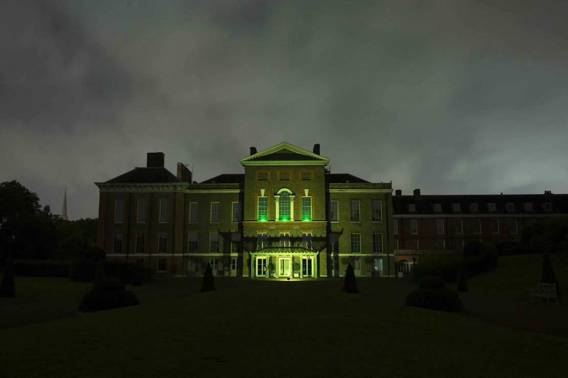 Kensington Palace's East facade is lit up in green to show support for survivors of the fire.