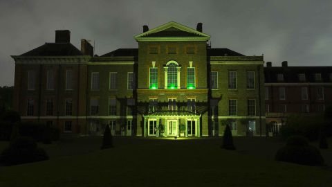 Kensington Palace's East facade is lit up in green to show support for survivors of the fire.