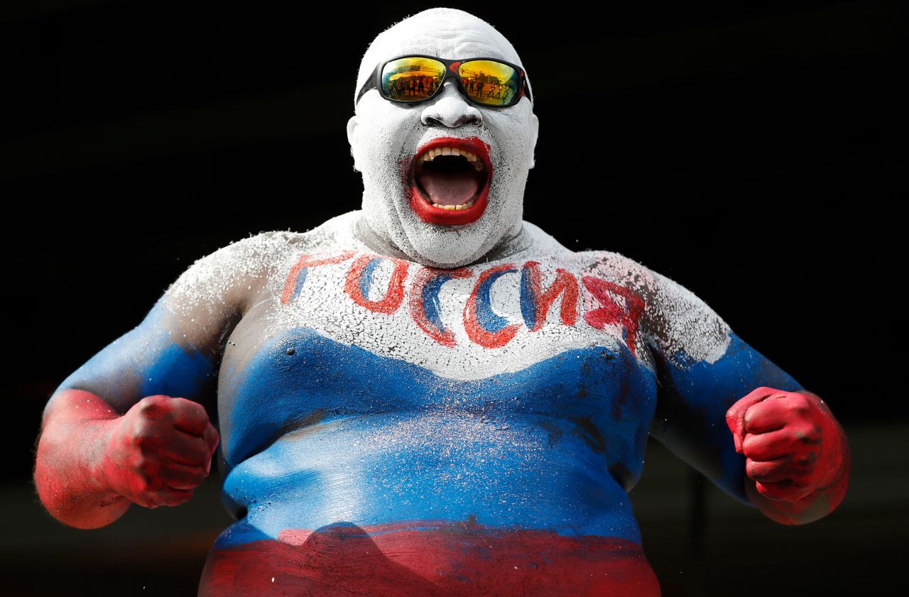 A fan wears body paint in Russia's colors before the opening match.