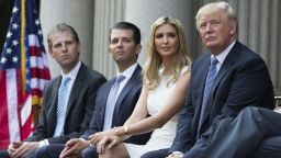 Donald Trump, right, sits with, from left, Eric Trump, Donald Trump Jr., and Ivanka Trump during a ground breaking ceremony for the Trump International Hotel on the site of the Old Post Office, on Wednesday, July 23, 2014, in Washington. (AP Photo)  