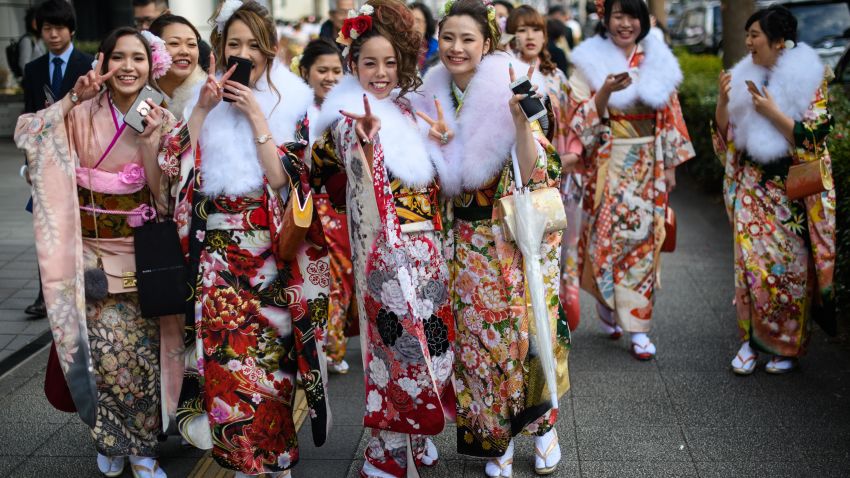 YOKOHAMA, JAPAN - JANUARY 08:  Women wearing kimonos gesture at the camera as they leave after attending a Coming of Age ceremony on January 8, 2018 in Yokohama, Japan. Coming of Age Day is a Japanese holiday held every January to celebrate people who have reached 20 - the official age of adulthood in Japan. Yokohama city, with almost 37,000 people turning 20 this year, is holding one of the largest events in the country.  (Photo by Carl Court/Getty Images,)