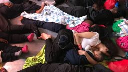 Women and children migrants who were rescued sleep on board the Aquarius in the "shelter" - an indoor space to shield them from the weather, on June 14, 2018. Most are suffering from sea sickness and are being treated by the MSF medical team with sea sickess medications.