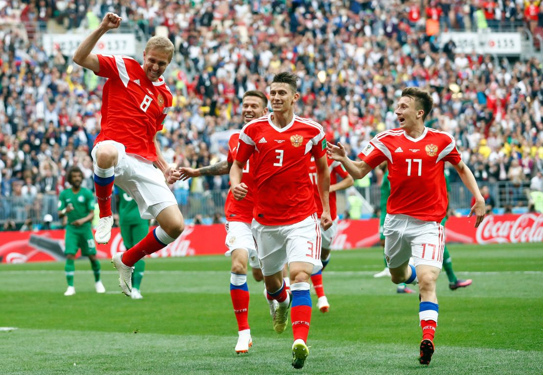 Yuri Gazinsky, left, celebrates with teammates after scoring Russia's opener.