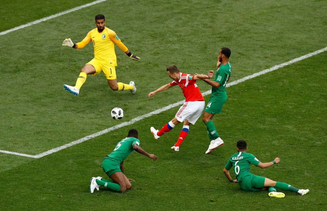 Denis Cheryshev, center, scores his side's second goal.